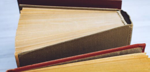 Book background. Top view of open hardback books on wooden table. Education, literature, knowledge, Back to school. Copy space